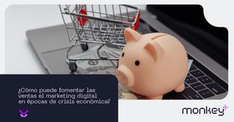 Cómo puede fomentar las ventas el marketing digital en épocas de crisis económica Alcancía de cerdito y carrito de compras sobre teclado de laptop representando economía